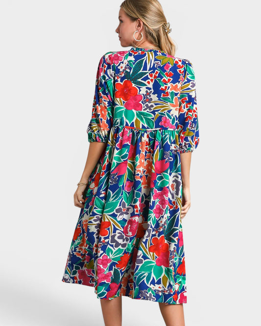 Woman wearing a colorful floral dress on a white background