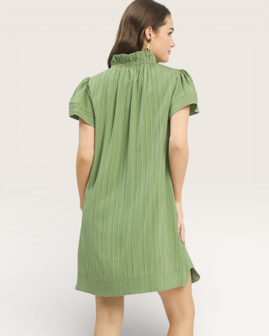 Woman wearing a green dress against a white background