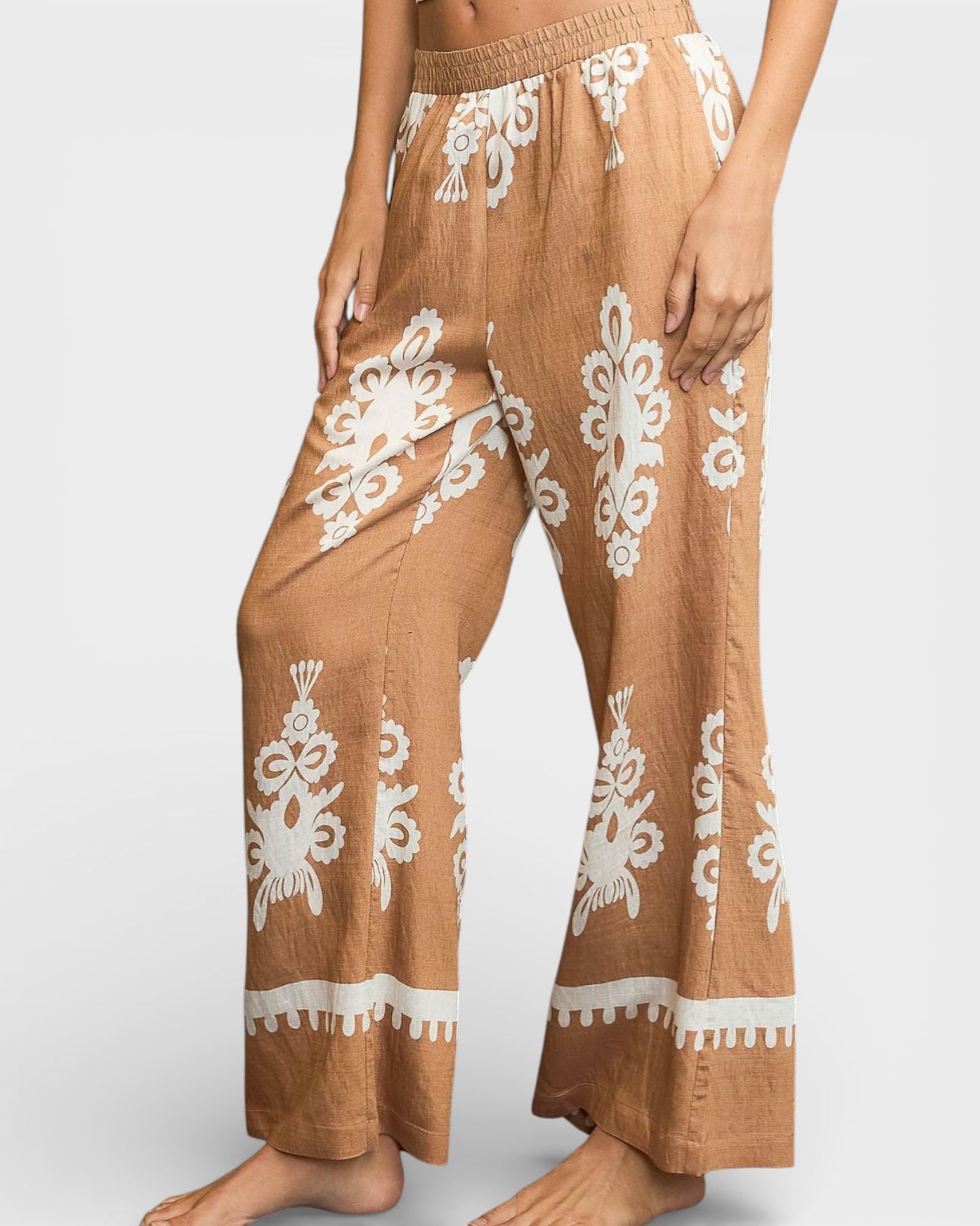 Brown pants with white lace patterns on a white background