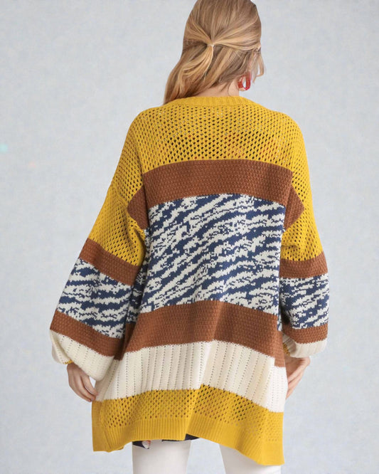 Person wearing a colorful striped sweater against a plain background