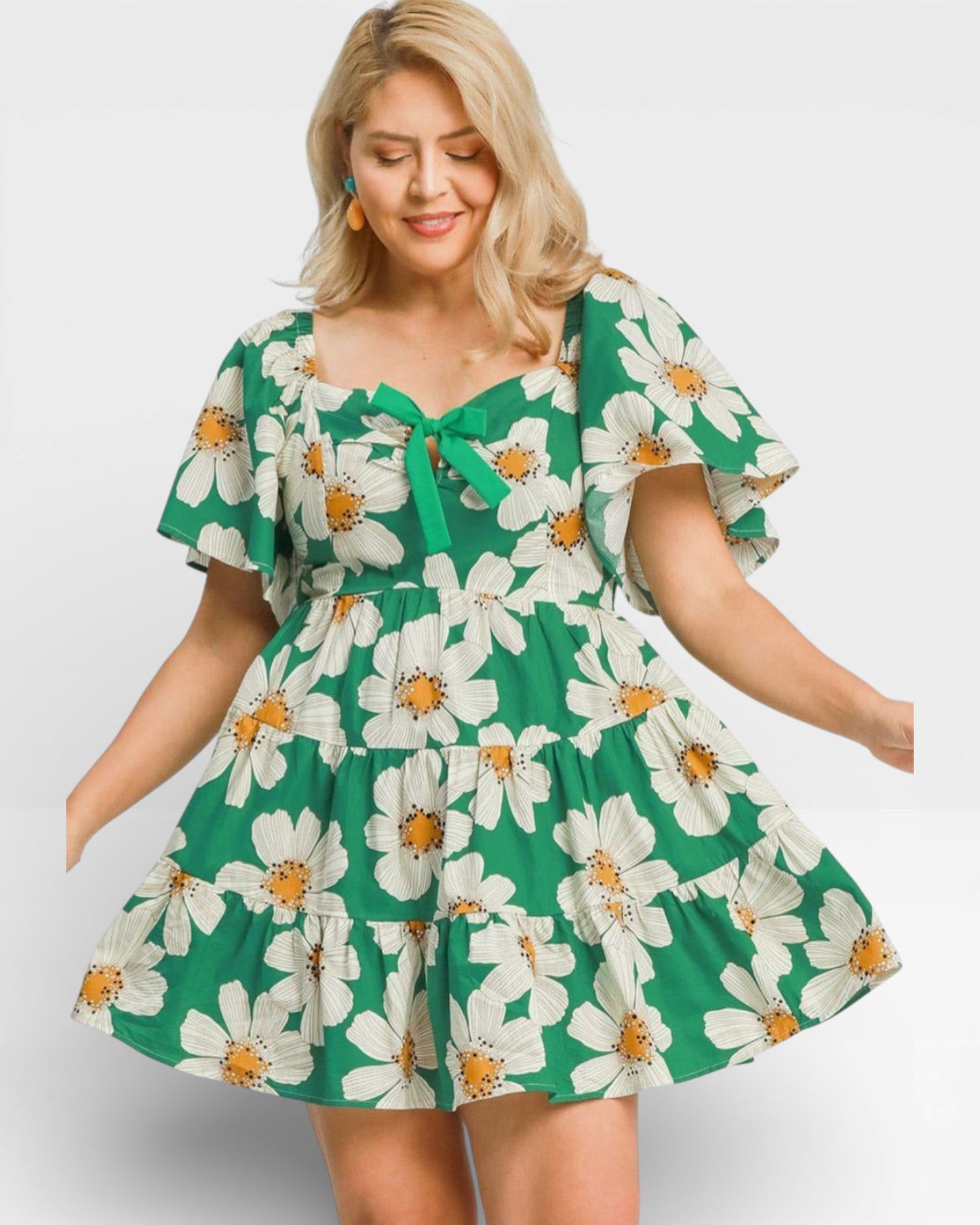 Woman wearing a green floral dress on a white background