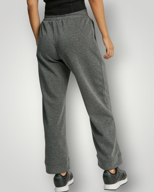 Gray sweatpants worn by a person on a white background