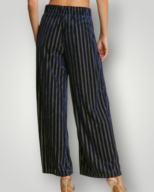 Navy striped pants worn by a person on a plain background