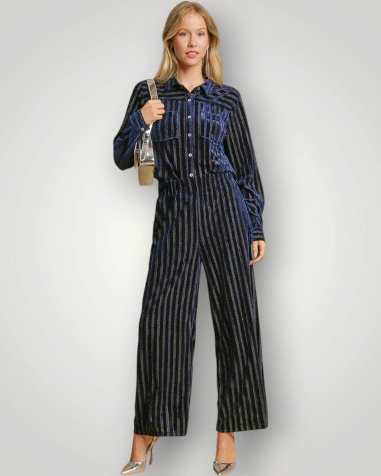 Woman wearing a blue and black striped jumpsuit on a white background