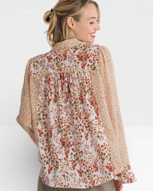 Woman wearing a floral blouse with a white background