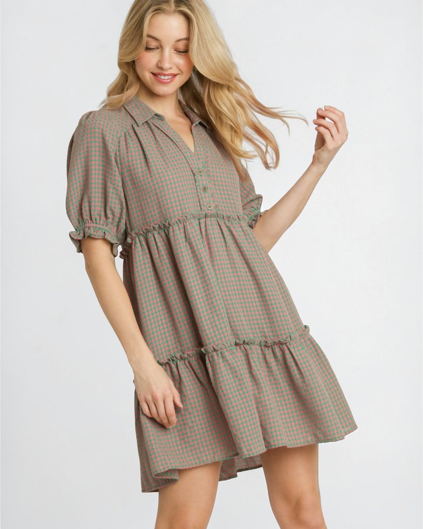 Woman wearing a plaid dress on a white background