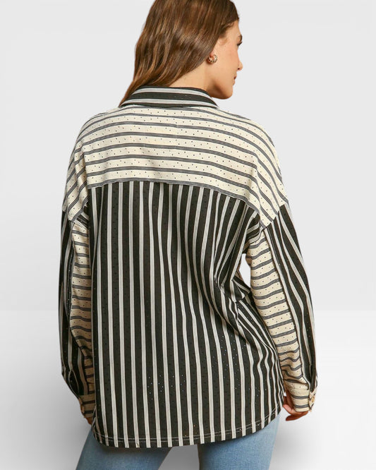 Person wearing a black and beige striped shirt on a white background