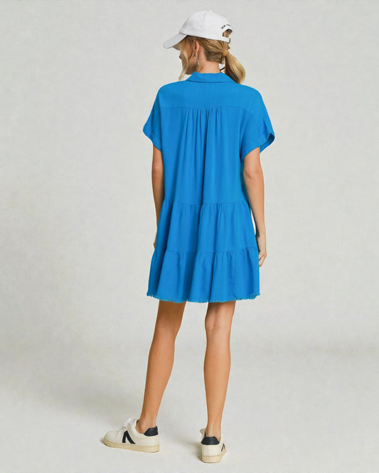 Person wearing a blue dress on a plain background