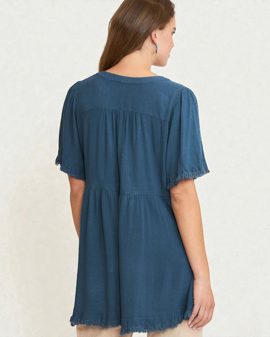 Woman wearing a blue denim dress against a white background