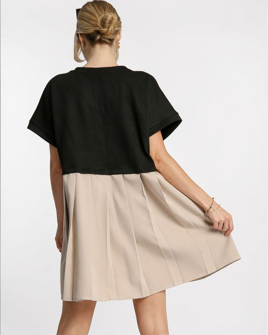 Woman wearing a black top and beige skirt on a white background