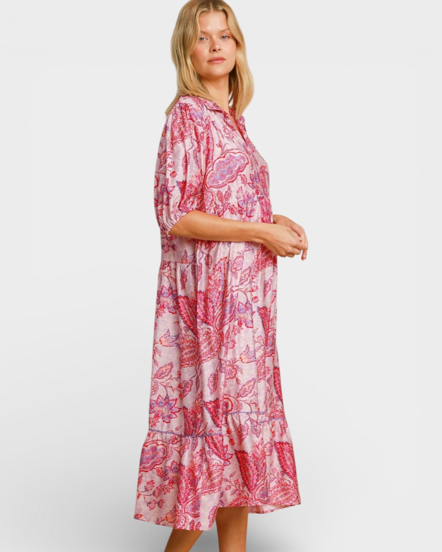 Woman wearing a pink floral dress on a white background
