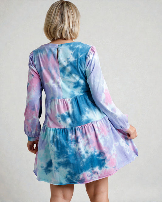 Tie-dye dress worn by a person on a plain background