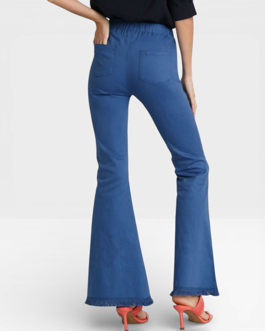 Blue flared pants worn by a person on a white background