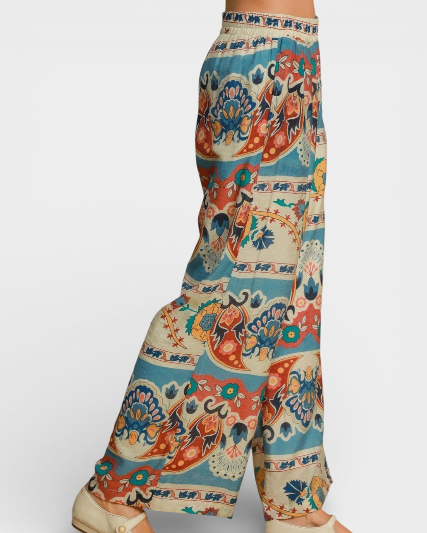 Colorful patterned pants on a mannequin against a white background