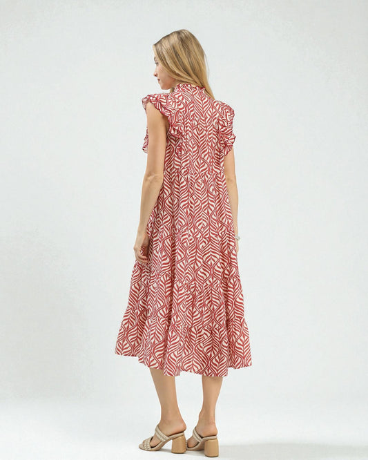 Woman wearing a red patterned dress on a white background