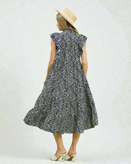 Woman wearing a black and white patterned dress on a white background