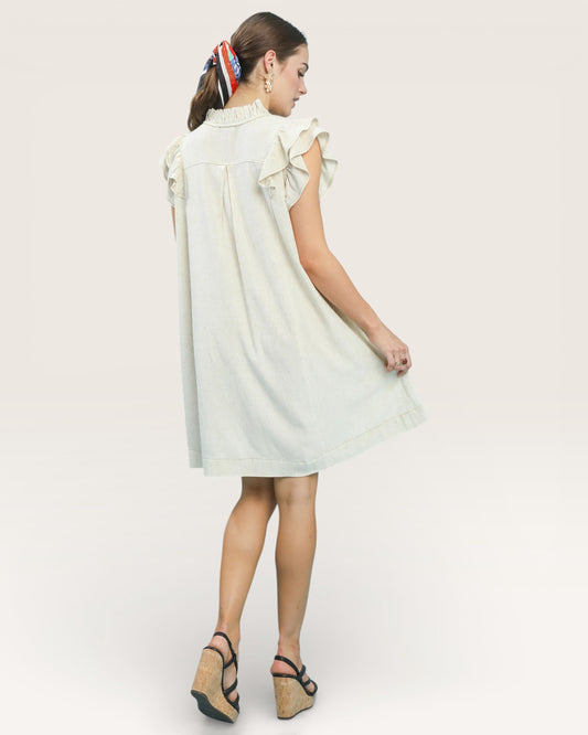 Woman wearing a light-colored dress on a white background