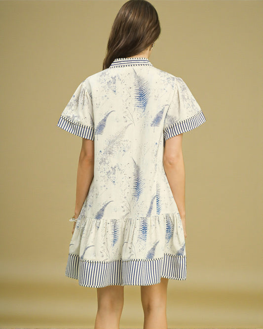 Woman wearing a patterned dress with a beige background