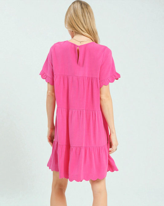 Pink dress worn by a person on a white background