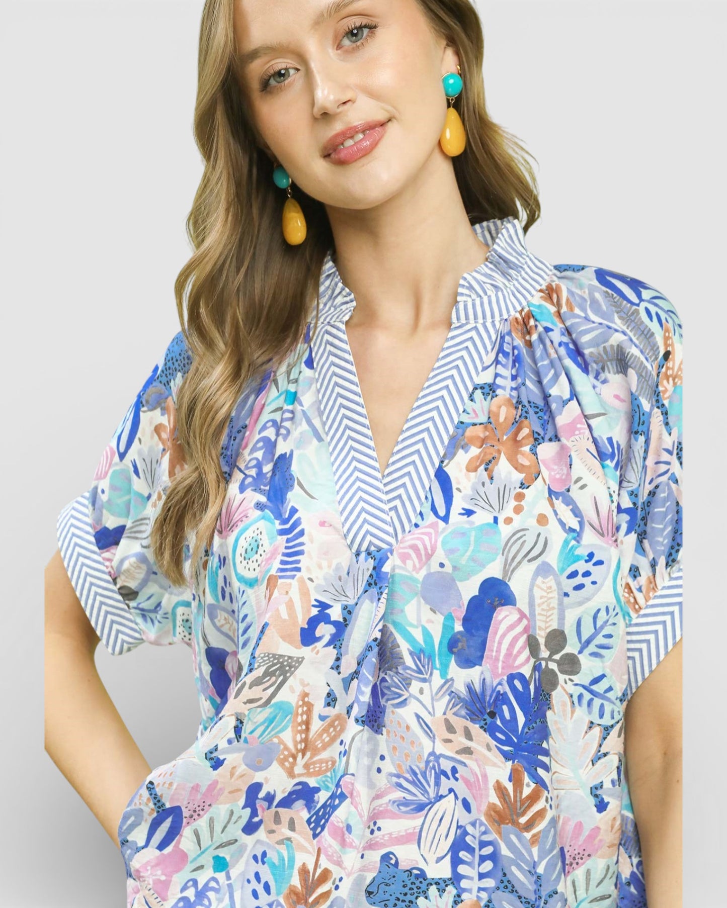 Woman wearing a colorful floral dress with a white background