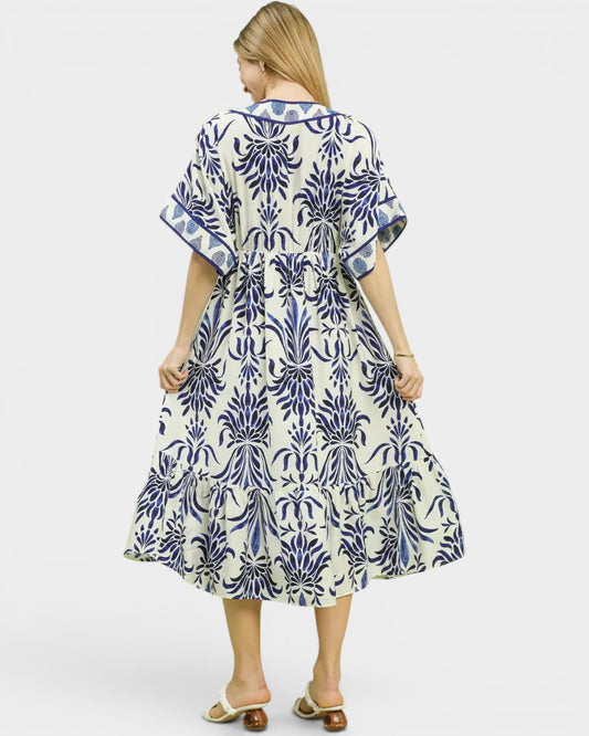Woman wearing a blue and white patterned dress on a white background