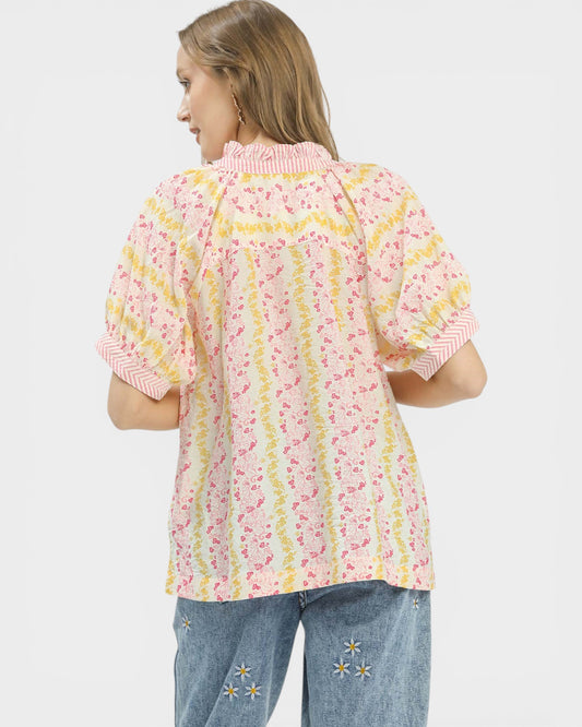 Woman wearing a floral blouse with a white background