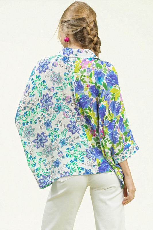 Woman wearing a colorful floral shirt on a white background