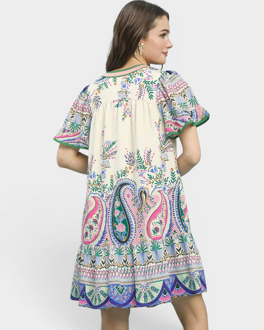Woman wearing a colorful patterned dress on a white background