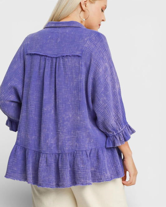 Purple checkered blouse with ruffled sleeves on a white background
