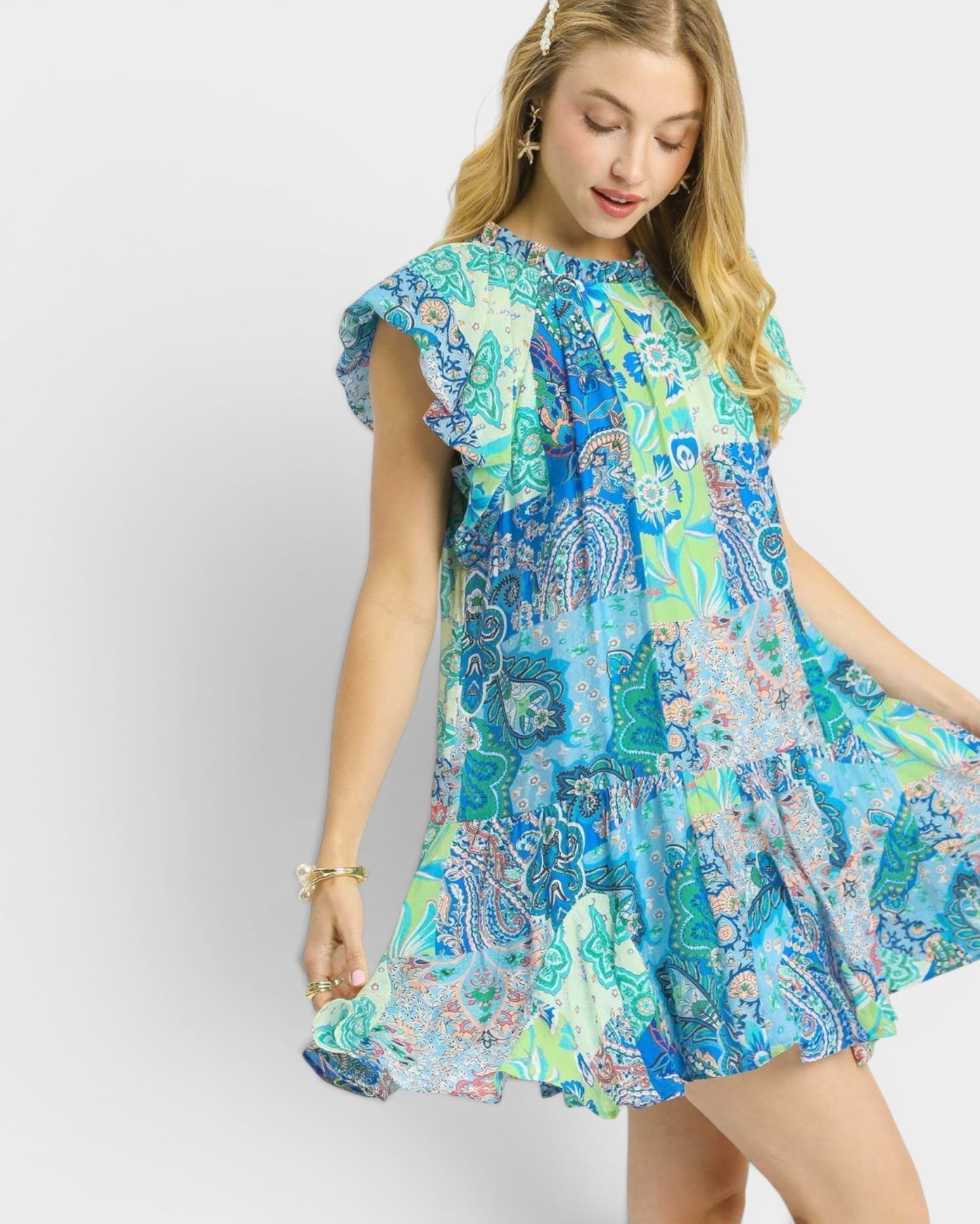 Woman wearing a colorful patterned dress on a white background