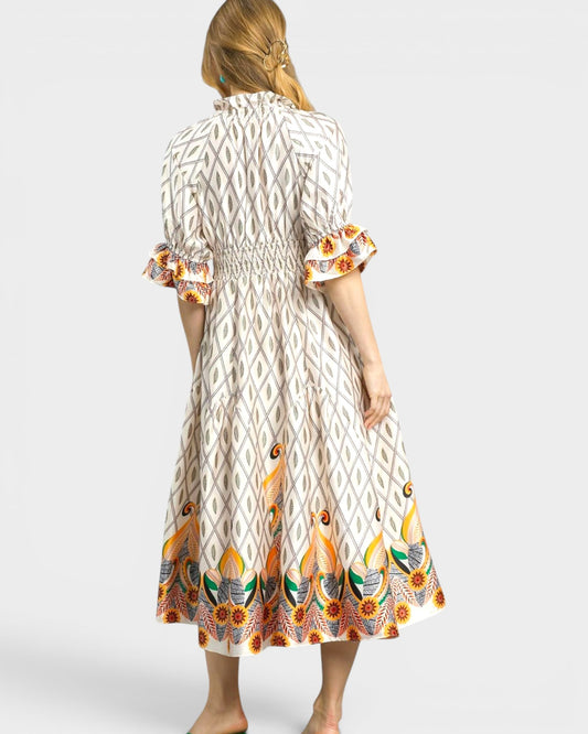 Woman wearing a patterned dress with a white background