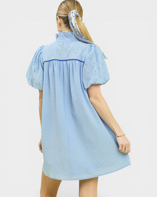 Light blue dress worn by a person on a white background