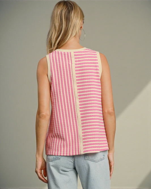 Woman wearing a pink and white striped sleeveless top against a neutral background