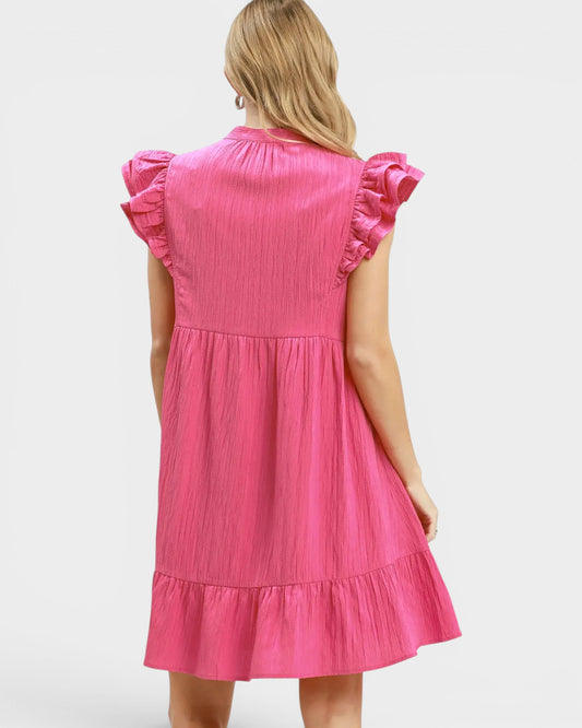 Pink dress with ruffled sleeves on a white background