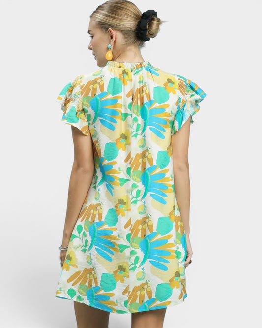 Woman wearing a colorful floral dress on a white background