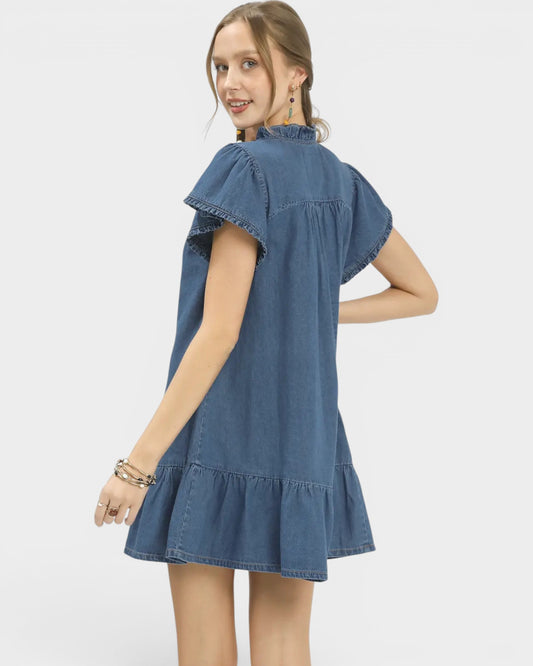 Woman wearing a blue denim dress on a white background