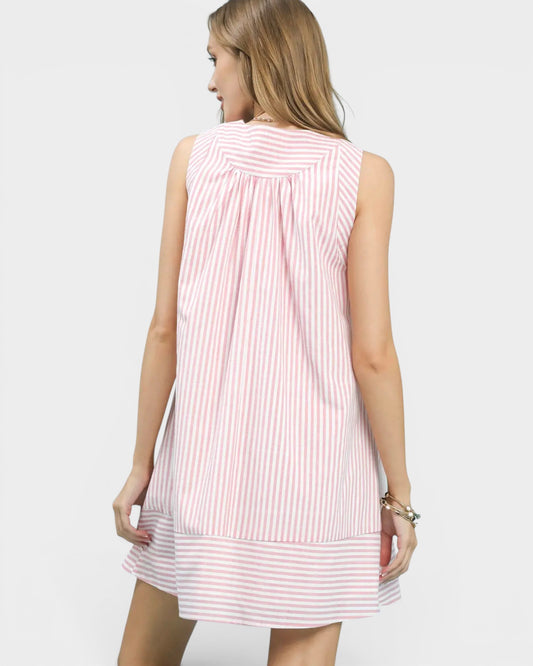 Woman wearing a pink and white striped dress on a white background