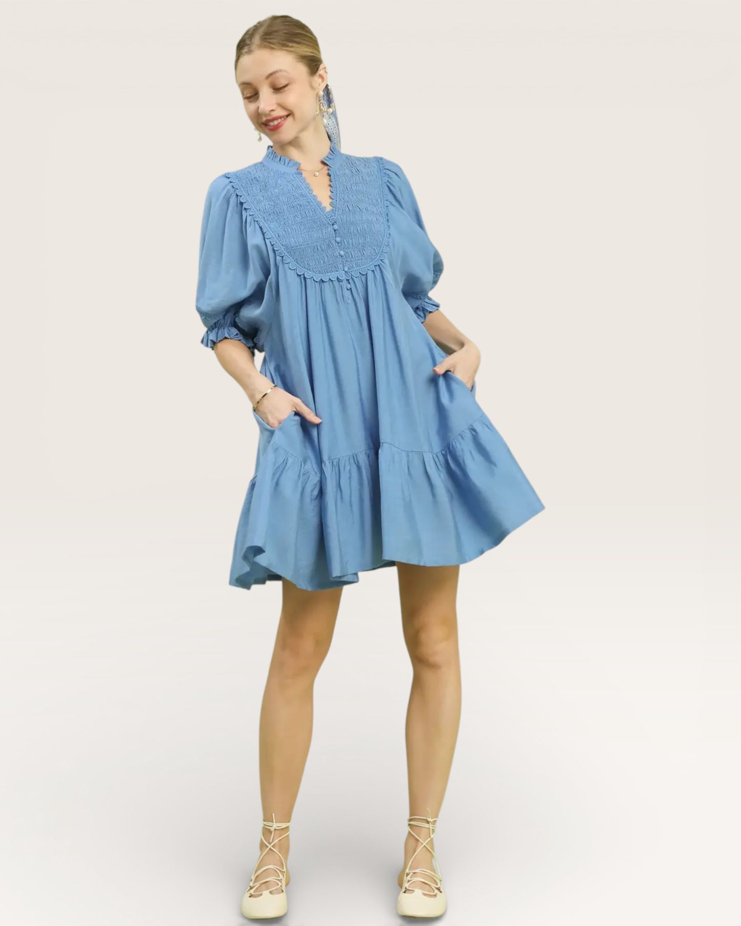 Woman wearing a blue dress on a white background