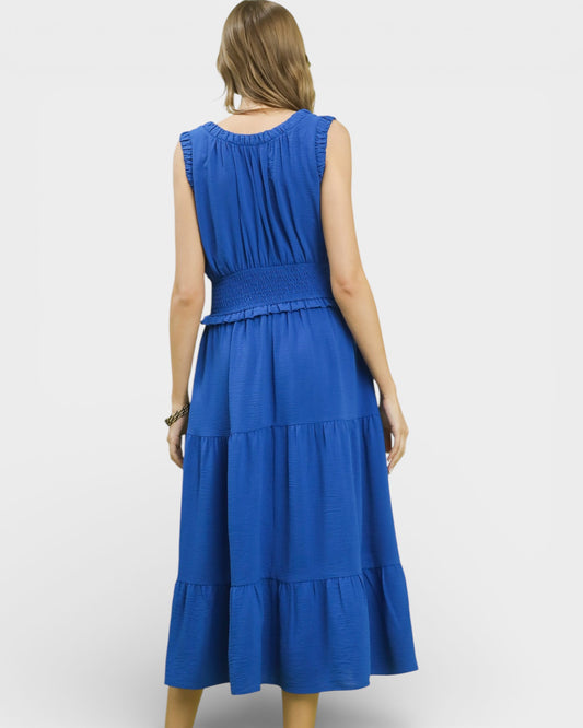 Blue dress with tiered skirt on a white background