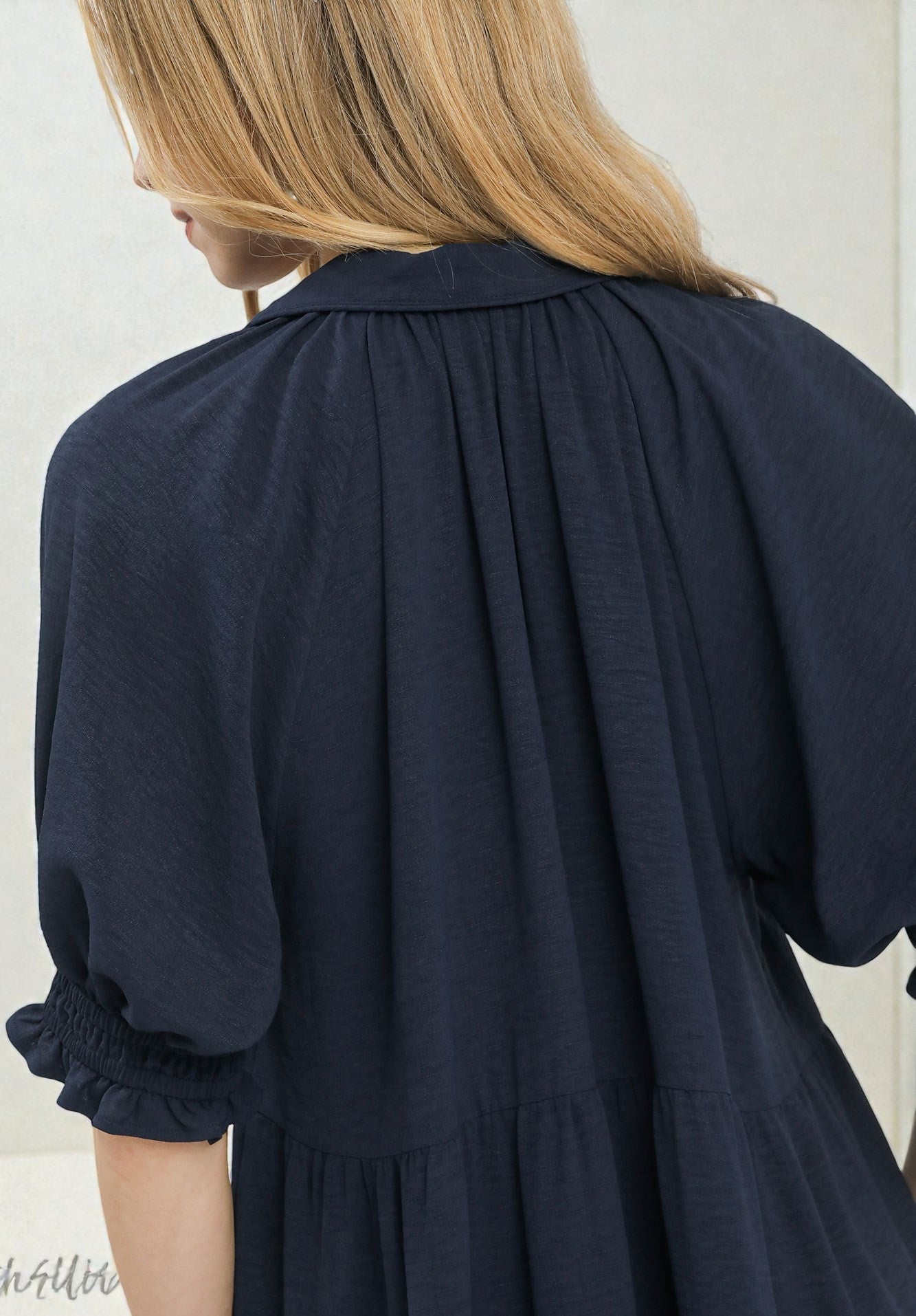 Navy blue dress with a plain background