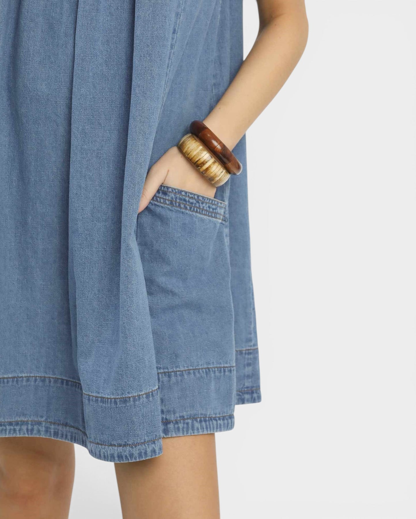 Blue denim dress with a plain background