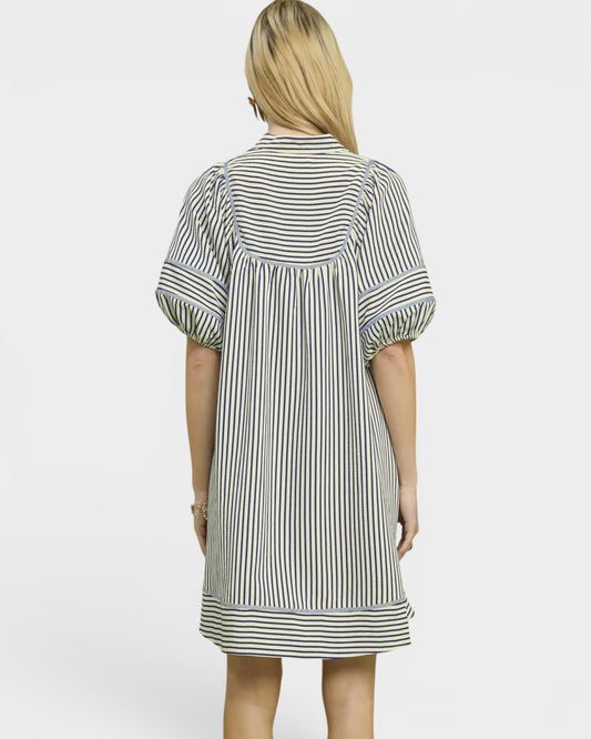 Woman wearing a striped dress on a white background
