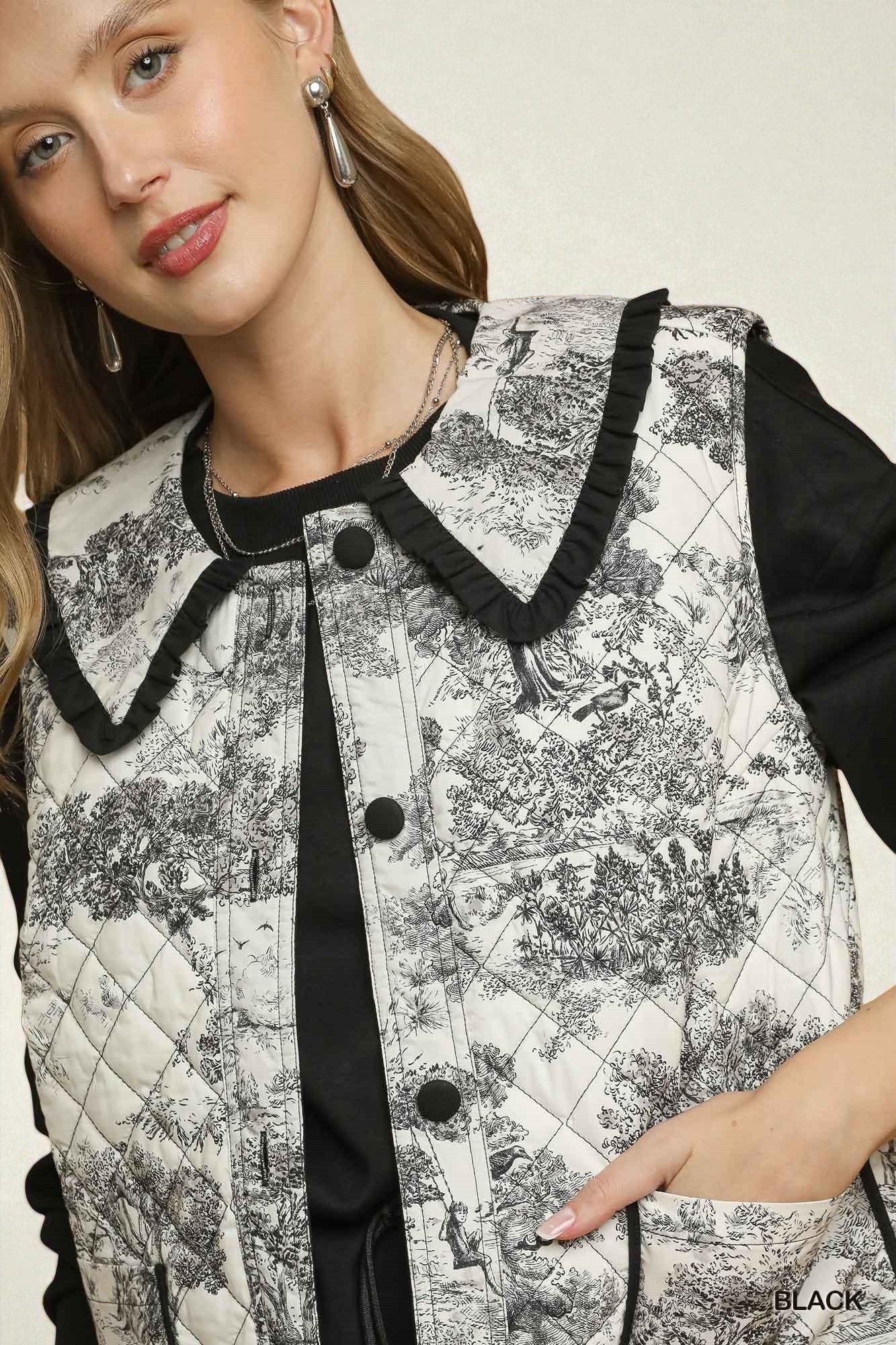 Woman wearing a black and white patterned vest with a plain background