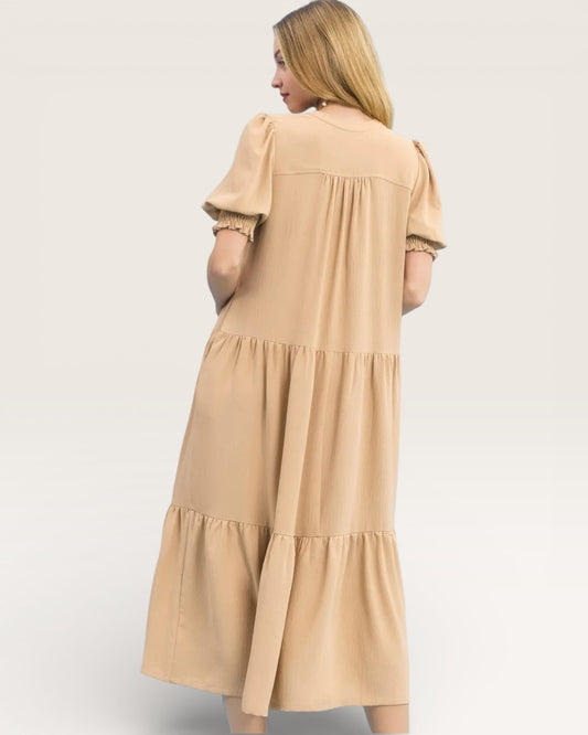 Woman wearing a beige dress on a white background