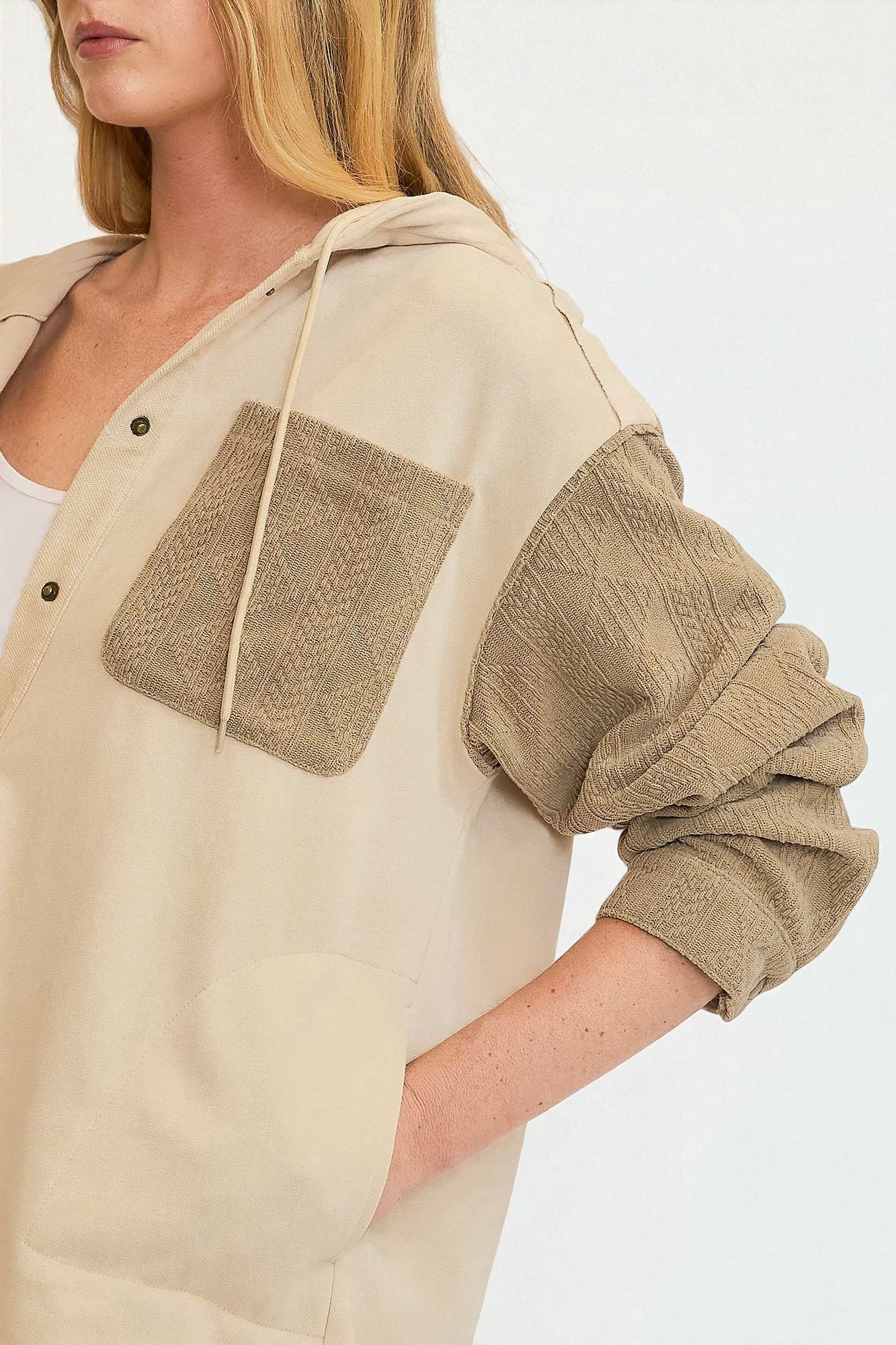 Beige and brown sweater with a hood on a white background