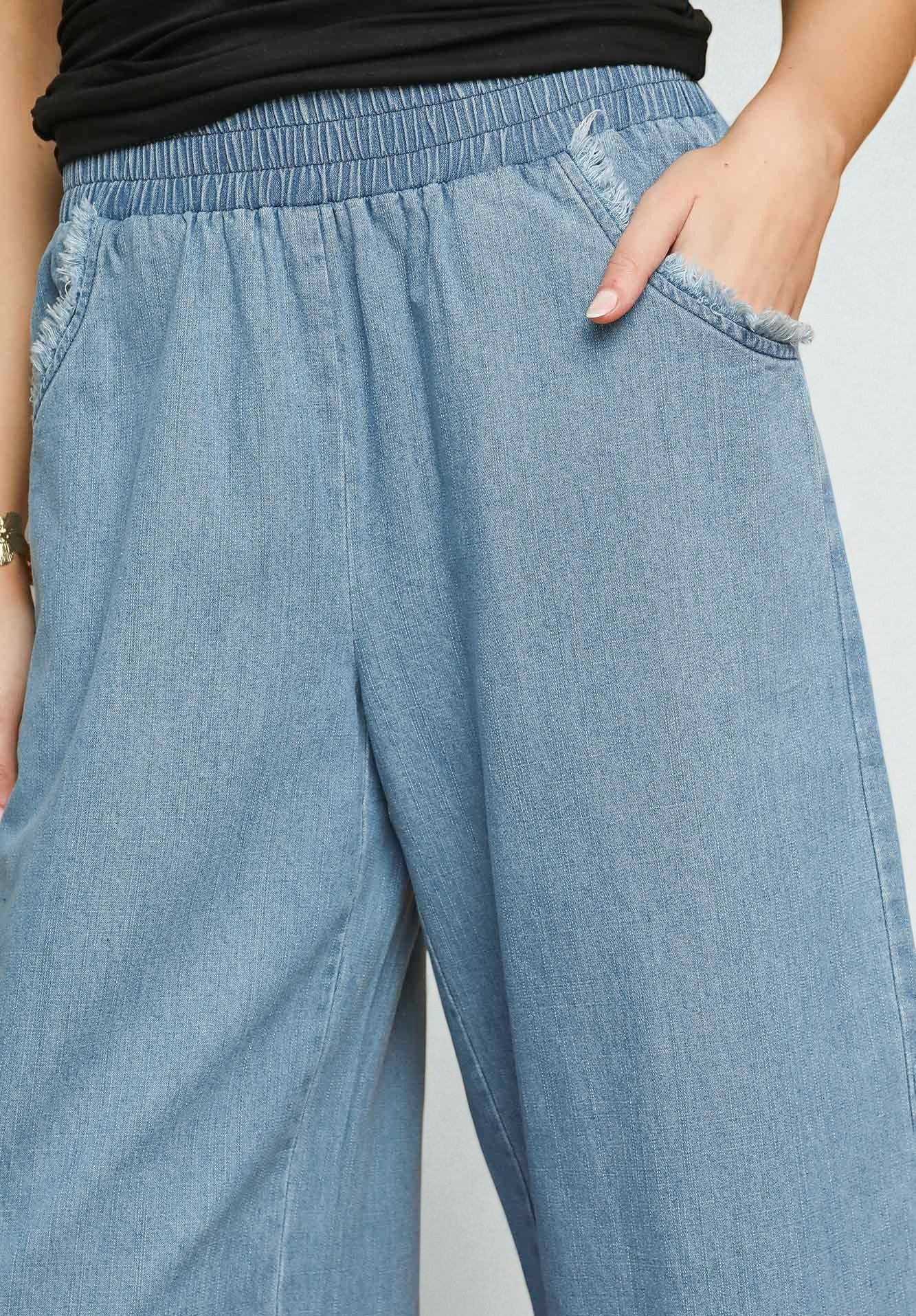 Light blue denim pants worn by a person on a plain background