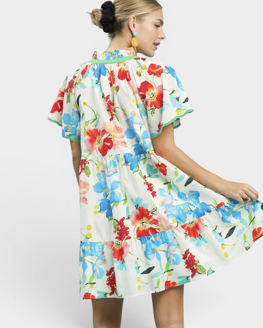 Woman wearing a colorful floral dress on a white background