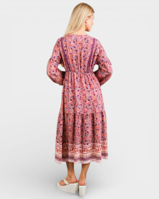 Woman wearing a patterned dress on a white background