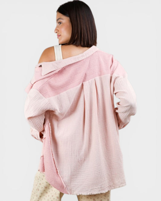 Woman wearing a pink oversized sweater on a white background