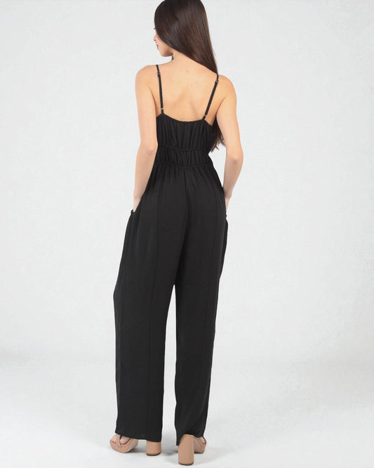 Black jumpsuit worn by a model on a white background